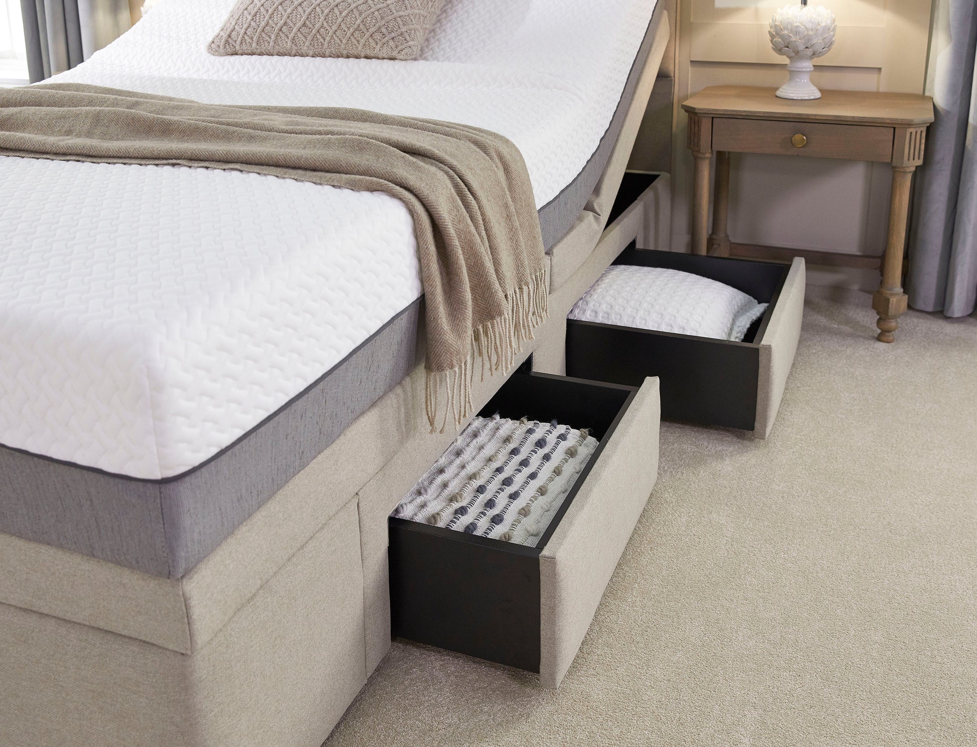 Bed with open storage drawers in a bedroom setting