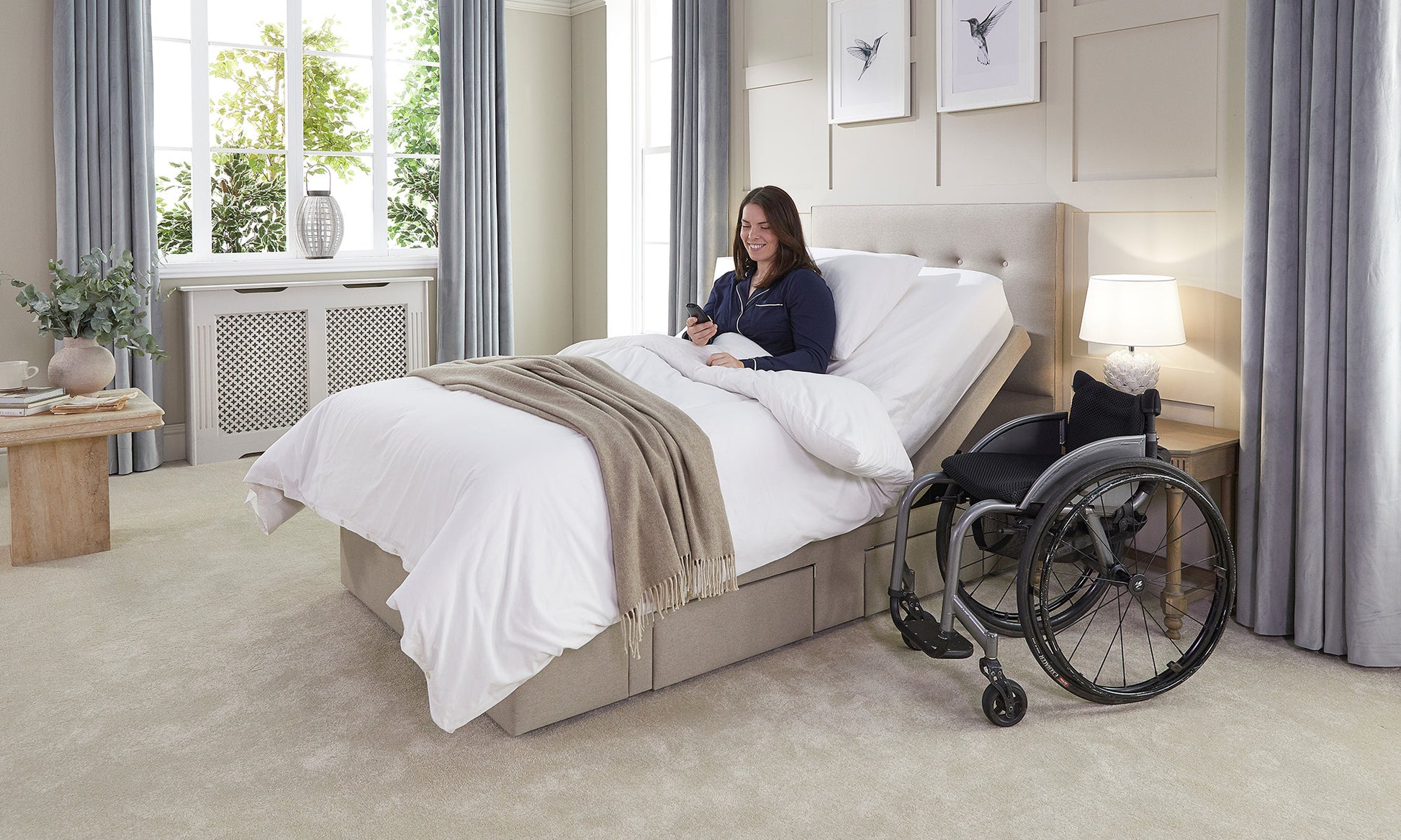 Woman in a wheelchair interacting with a bed in a home setting