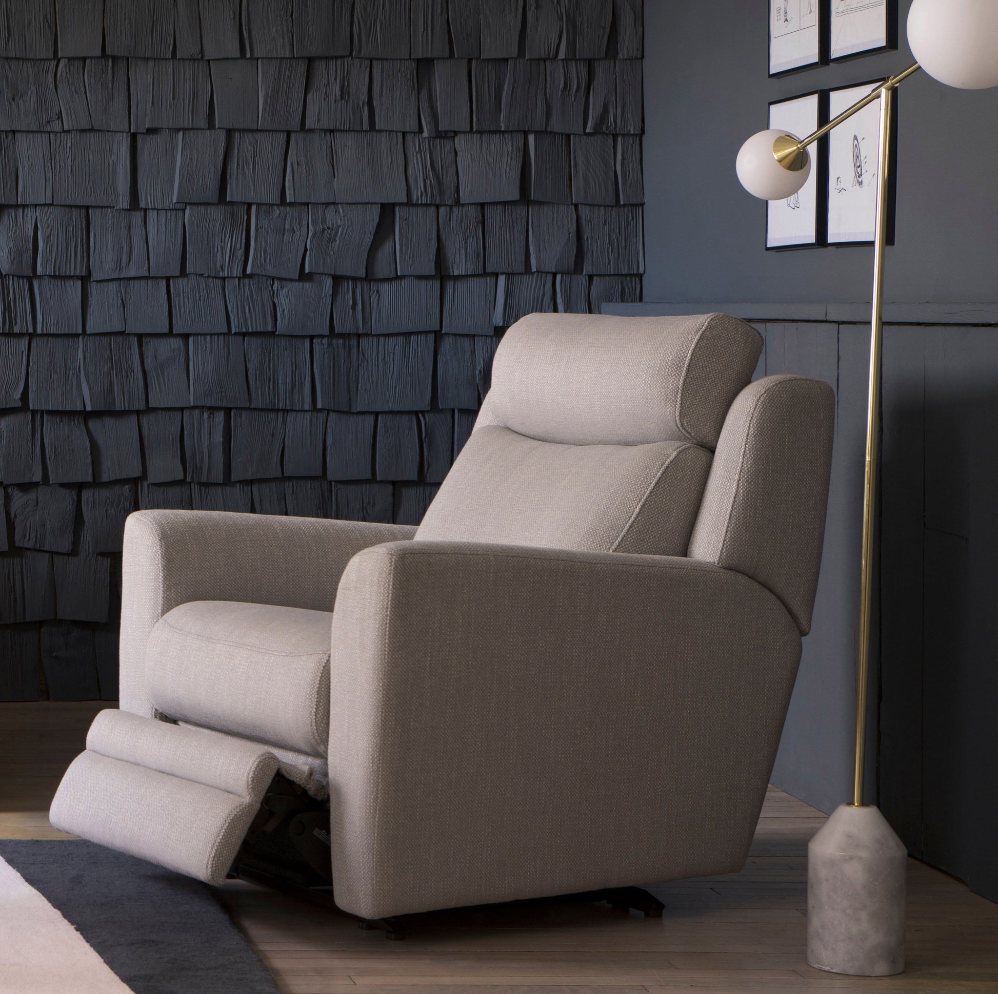 Beige recliner chair in a modern room with textured wall and floor lamp.