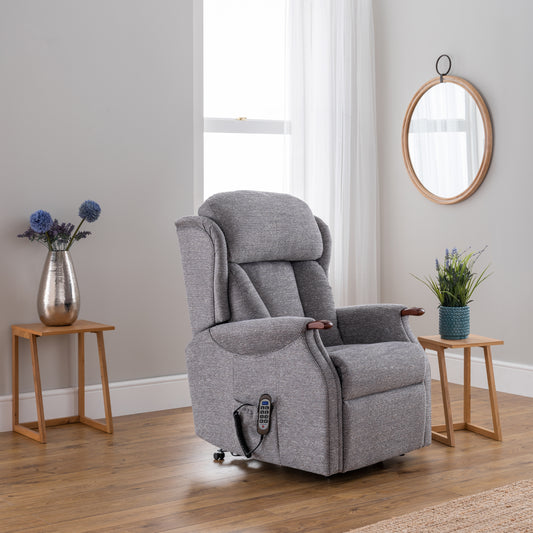 Gray recliner chair in a room with wooden floors and light gray walls.