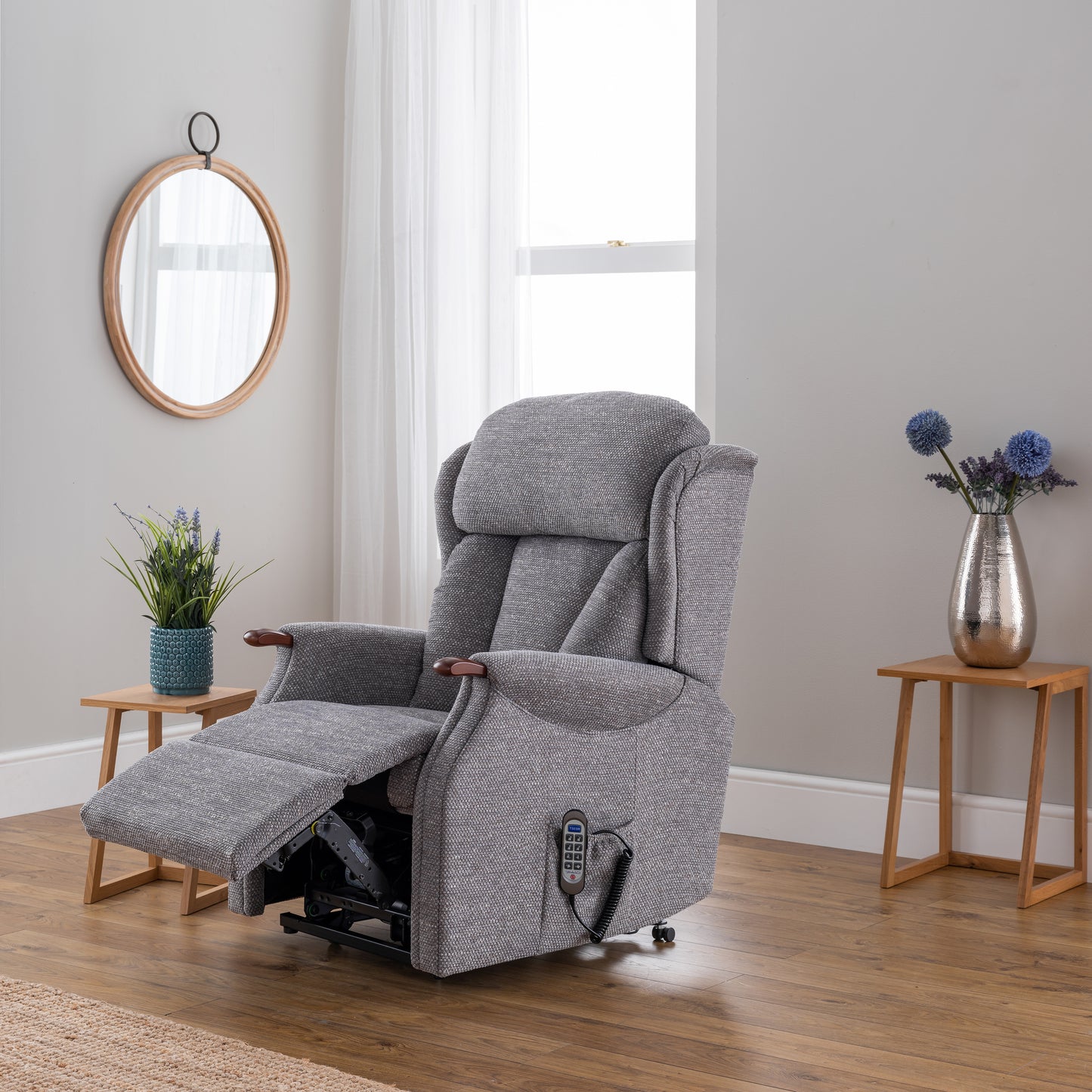 Gray recliner chair in a room with wooden flooring and decorative elements.