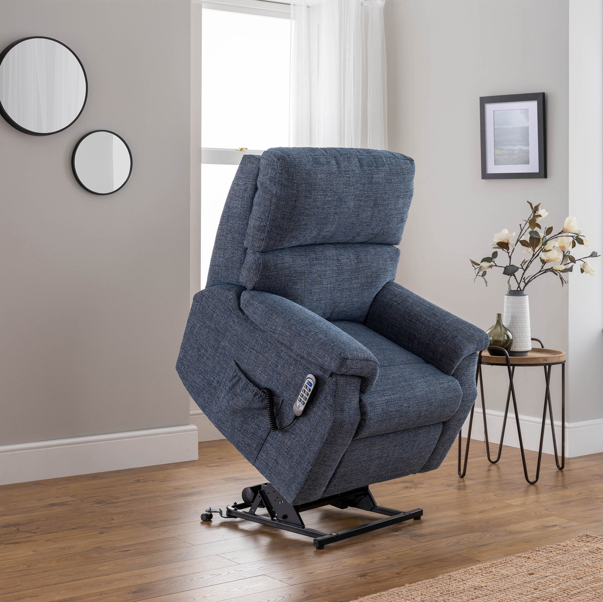 Blue celebrity newstead lift chair in a living room setting with a side table and decor.