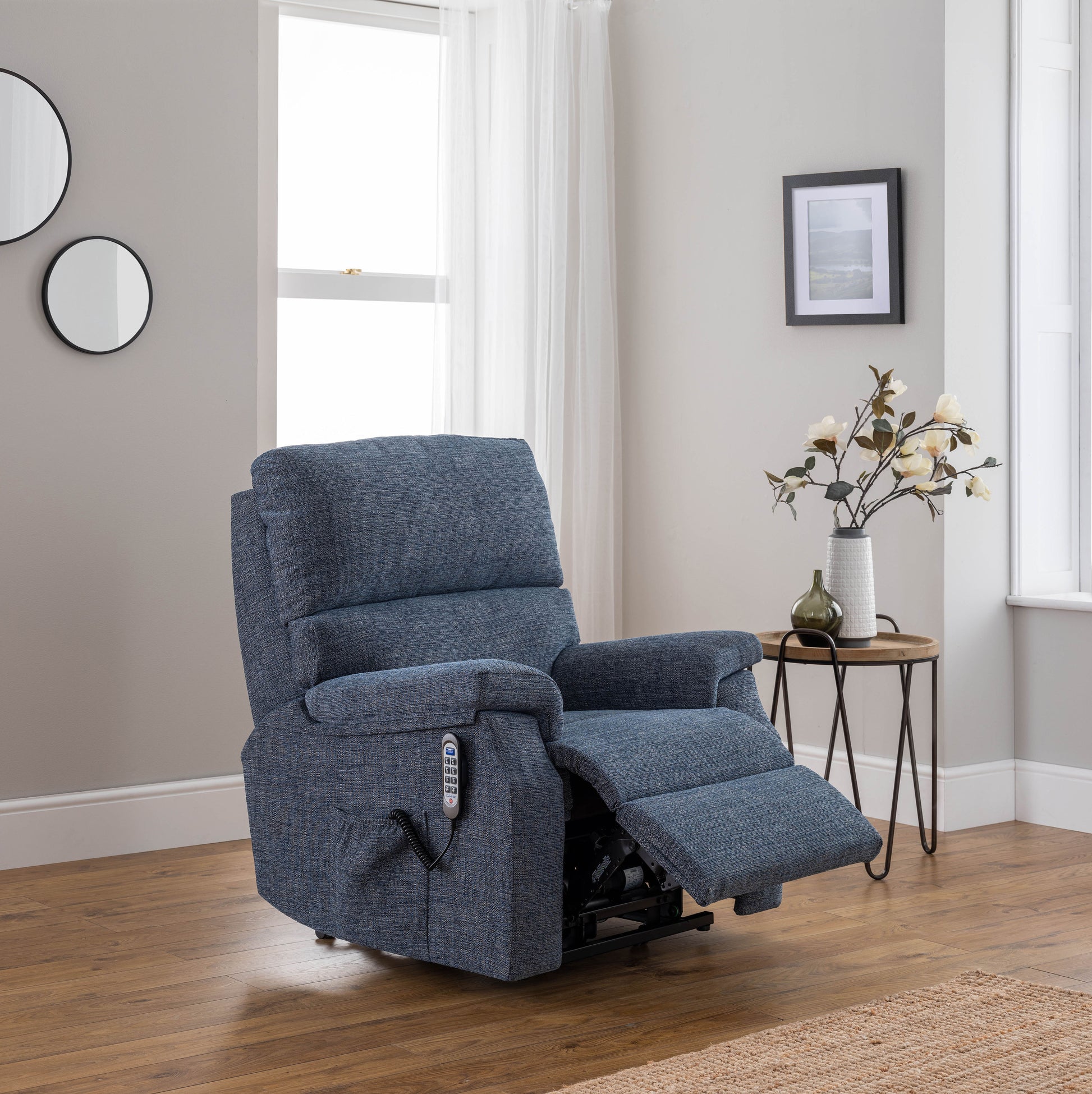 Blue celebrity newstead recliner chair in a room with a side table and decor