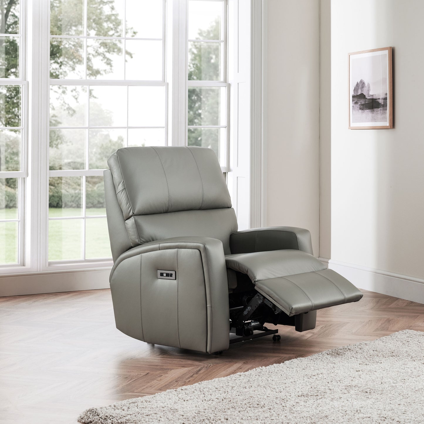 Gray celebrity southwell recliner chair in a room with large windows and a rug.