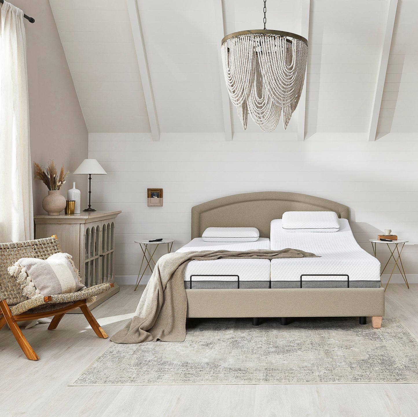 Modern bedroom with a bed, chair, and decorative elements.