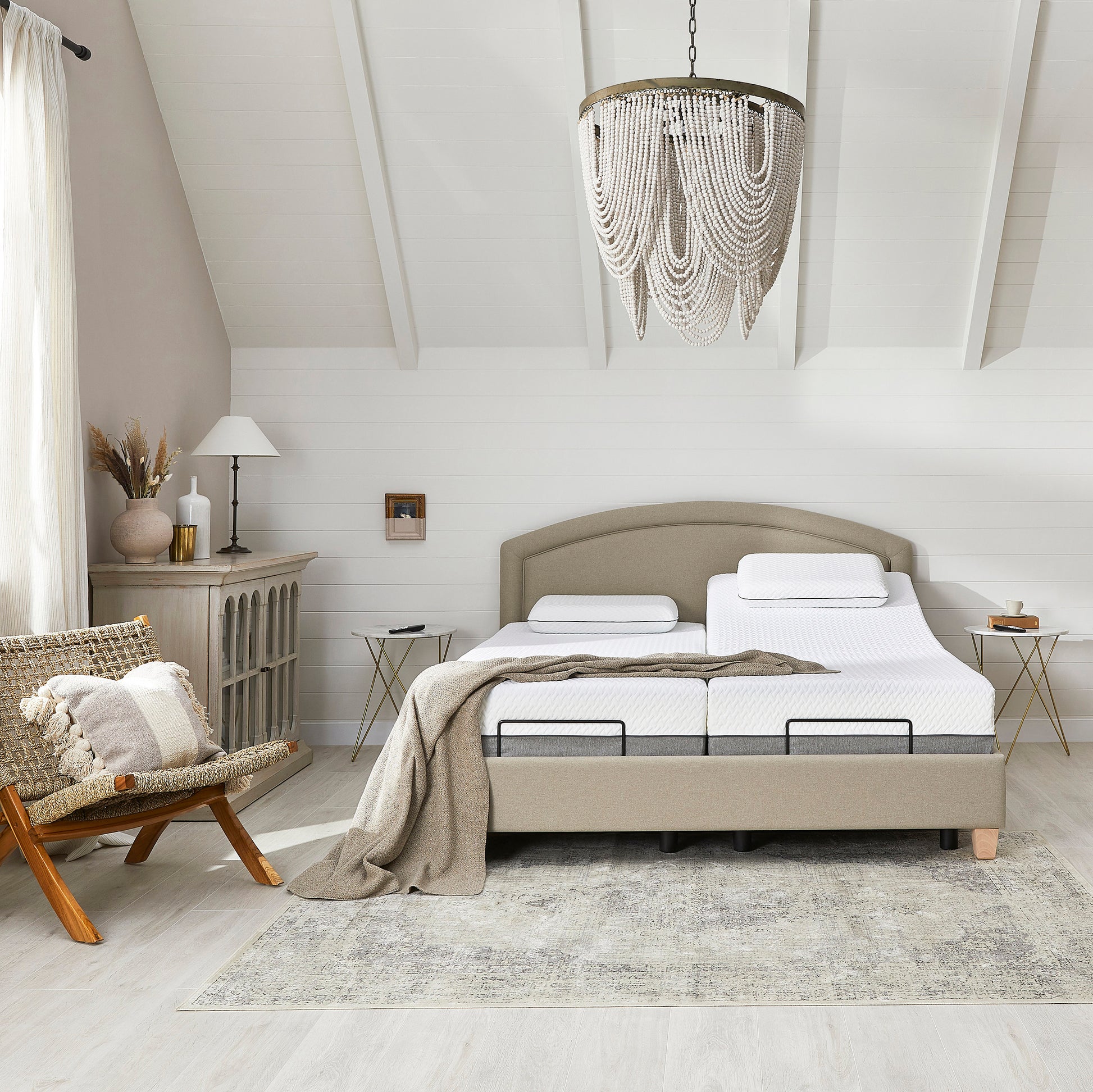 Modern bedroom with a bed, chair, and decorative elements.