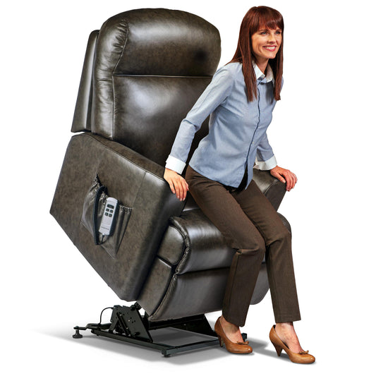 Woman sitting on a Sherborne Harrow riser recliner chair in a home setting 