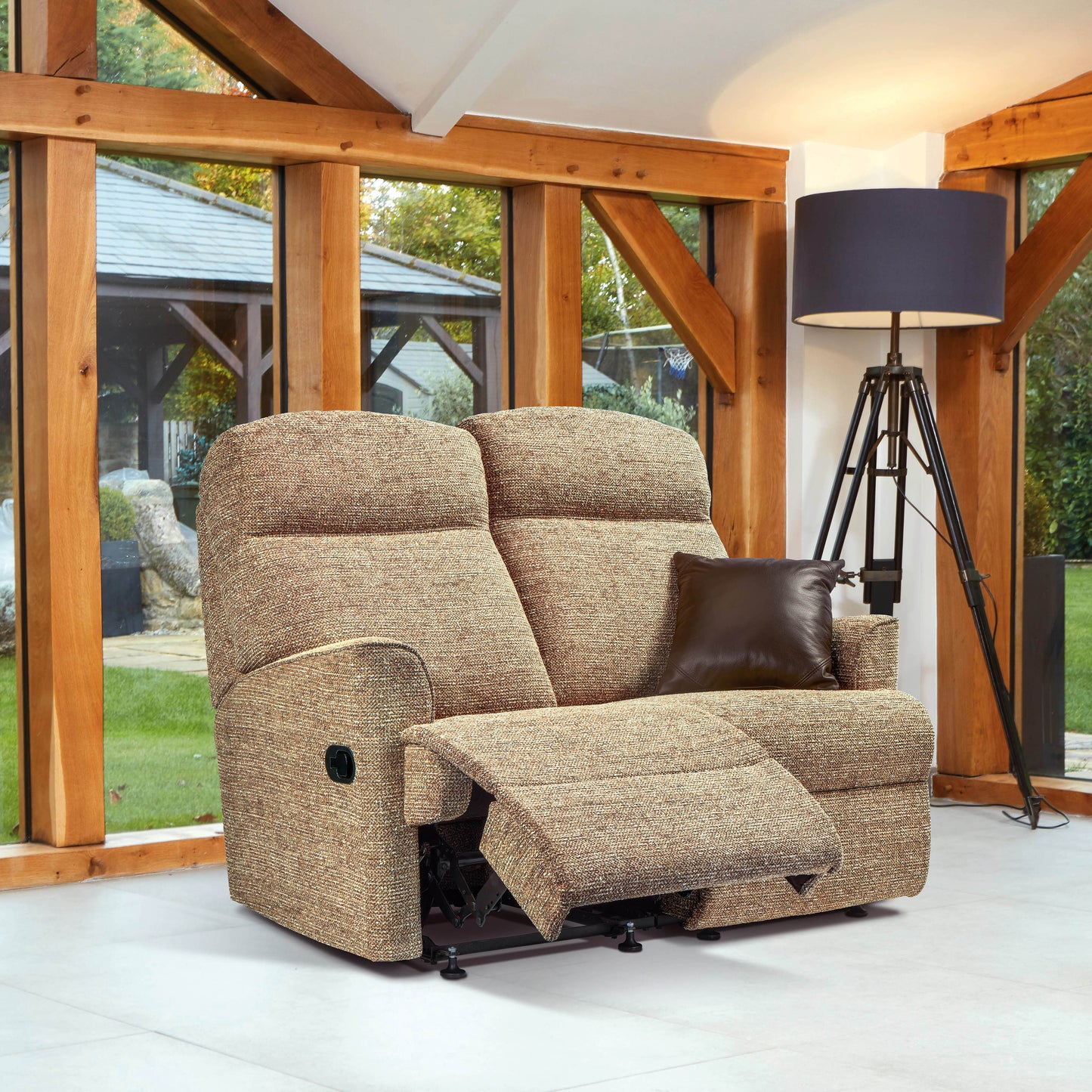 Sherborne Harrow recliner sofa in a room with wooden beams and large windows.