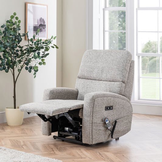 Gray Celebrity Southwell recliner chair in a living room with a plant and window in the background