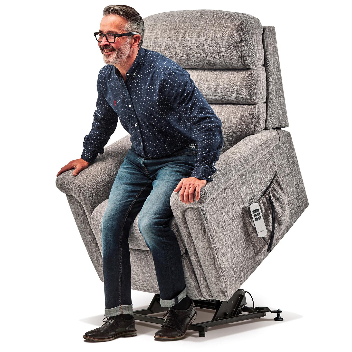 man in a red shirt sitting in a grey Sherborne Comfi-Sit recliner chair on a white background