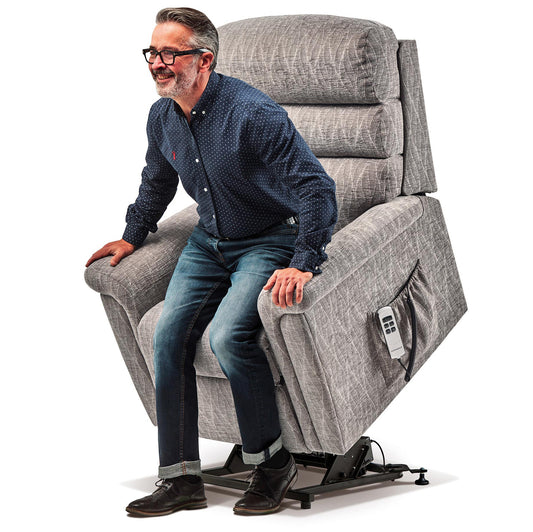 man in a red shirt sitting in a grey Sherborne Comfi-Sit recliner chair on a white background