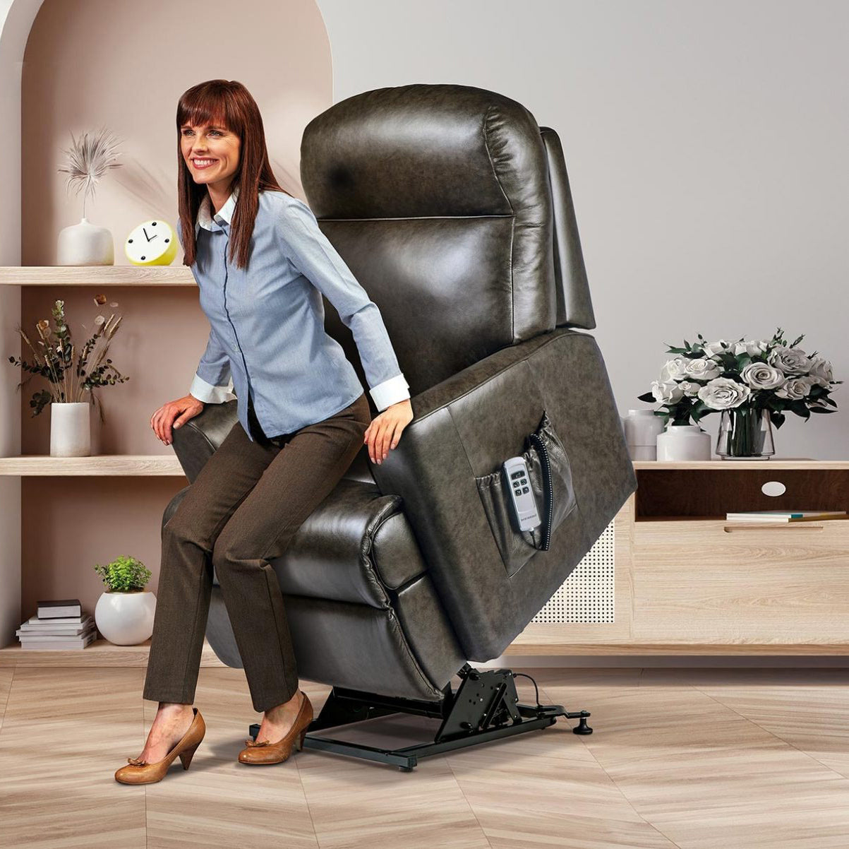 Woman using a Sherborne Harrow riser recliner chair in a home setting with decor elements.