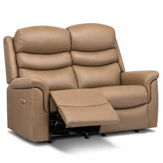 A tan leather reclining loveseat with the right footrest extended, shown on a clean white background.