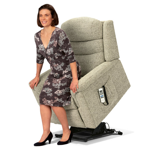 Woman sitting on a gray recliner chair with a remote control on a white background