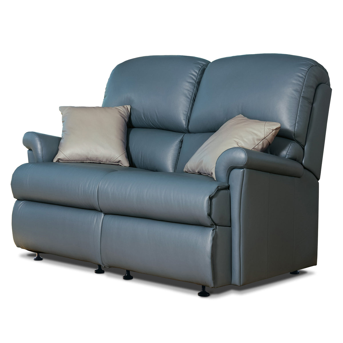 A blue leather reclining loveseat with two beige throw pillows, shown on a plain white background.