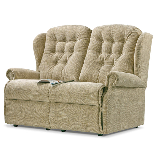 Beige recliner sofa with tufted backrest on a white background