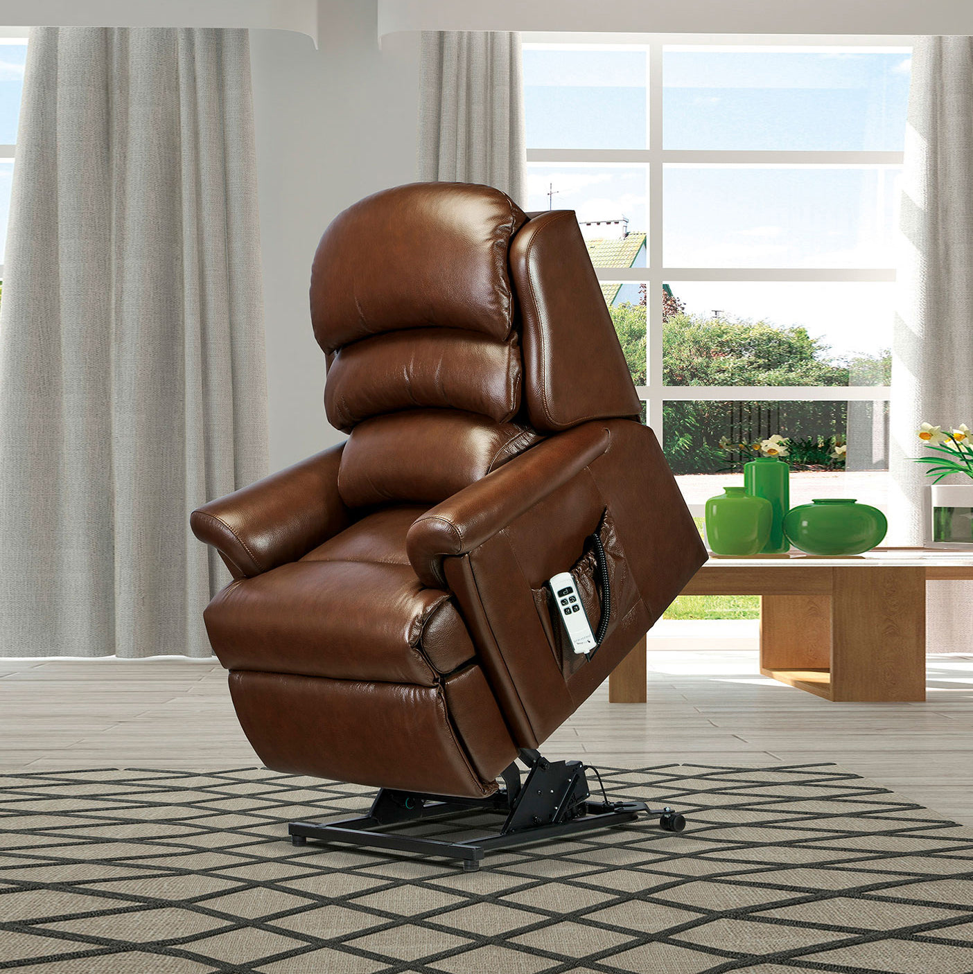 Brown leather Sherborne Albany riser recliner chair in a room with large windows and a table with green bowls.