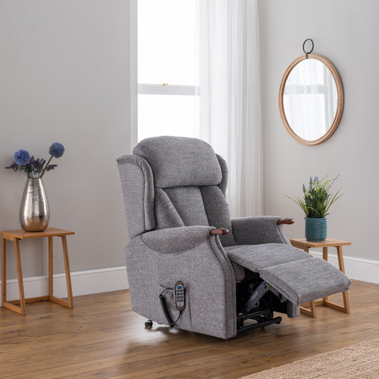 Gray recliner chair in a room with wooden floors and light gray walls.