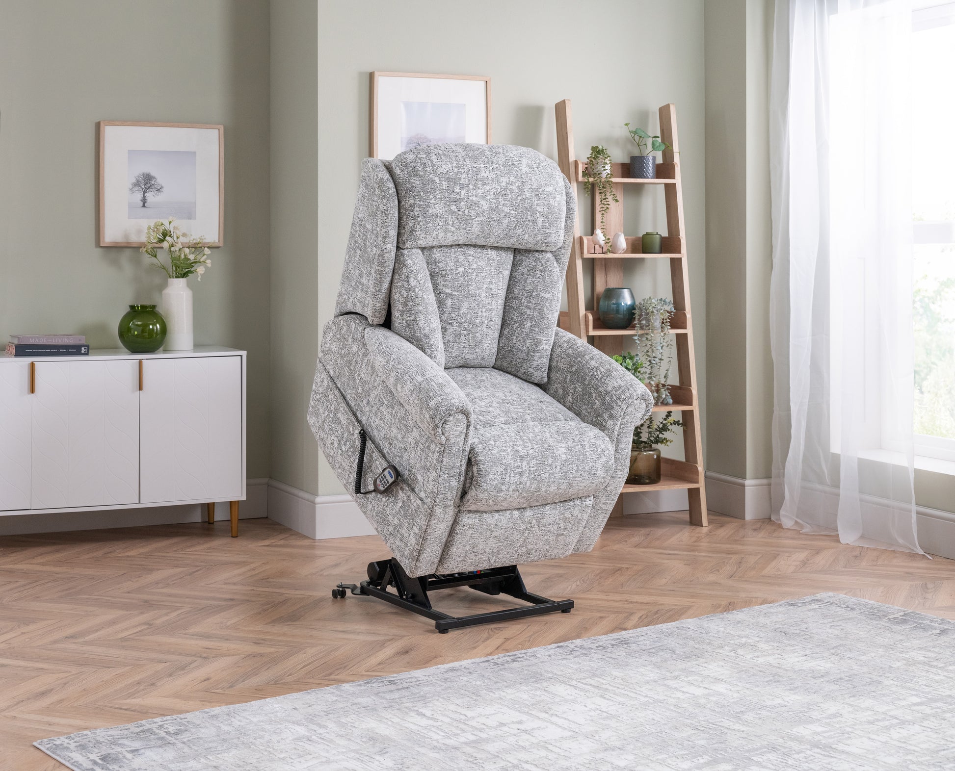 Gray recliner chair in a living room setting with a sideboard and bookshelf.